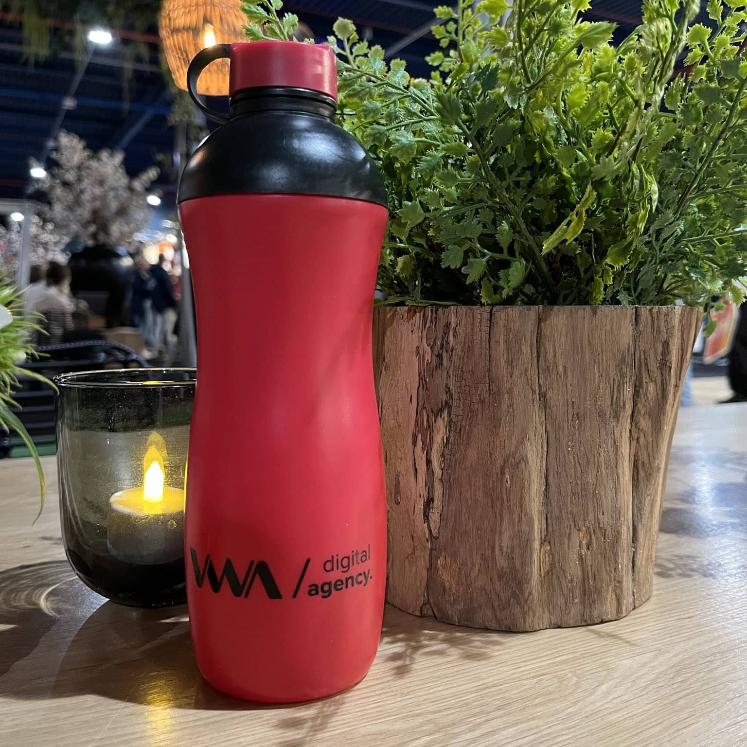 Laser engraving on a red Oasus water bottle